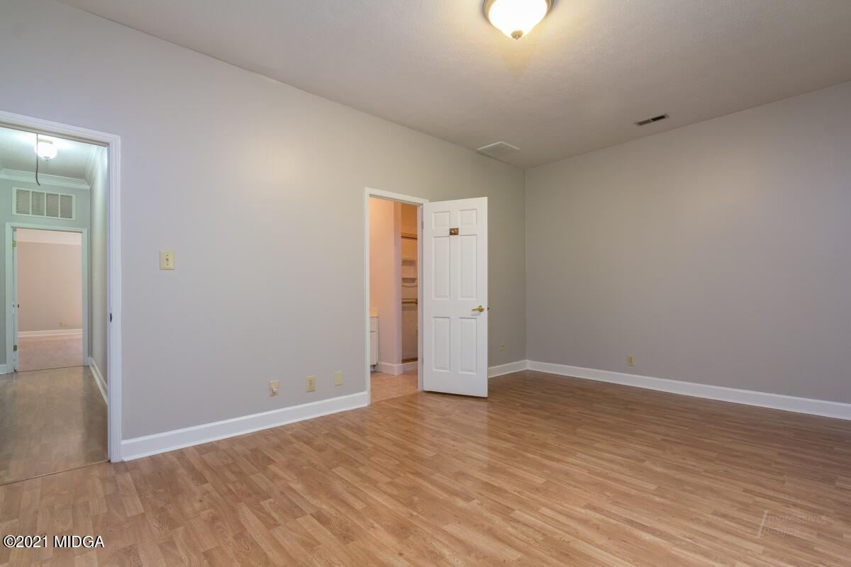 903 Tucker Road Macon, GA 31210 - Photo 20 of 31 an empty room with wooden floor and windows