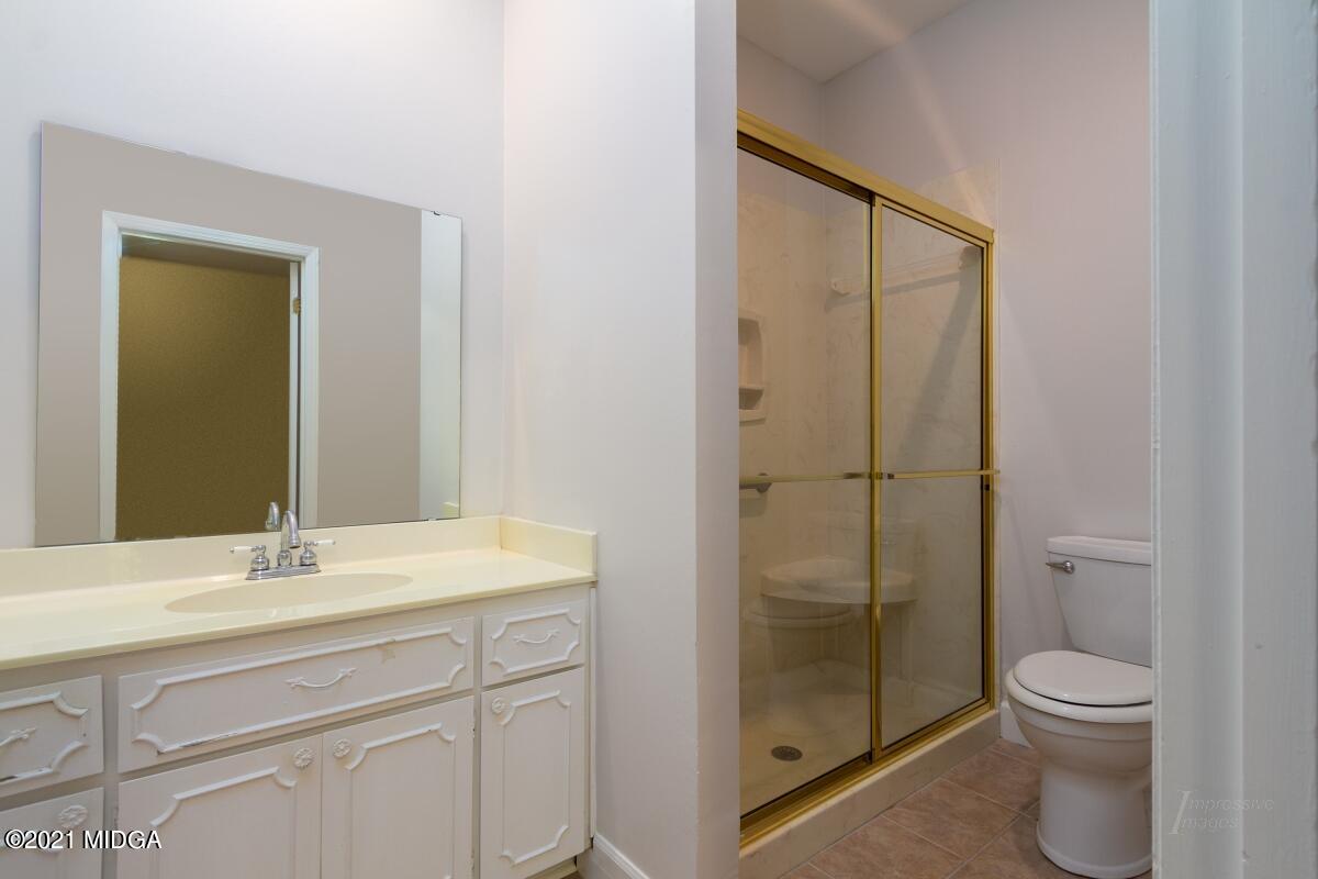 903 Tucker Road Macon, GA 31210 - Photo 21 of 31 a bathroom with a sink a toilet and shower