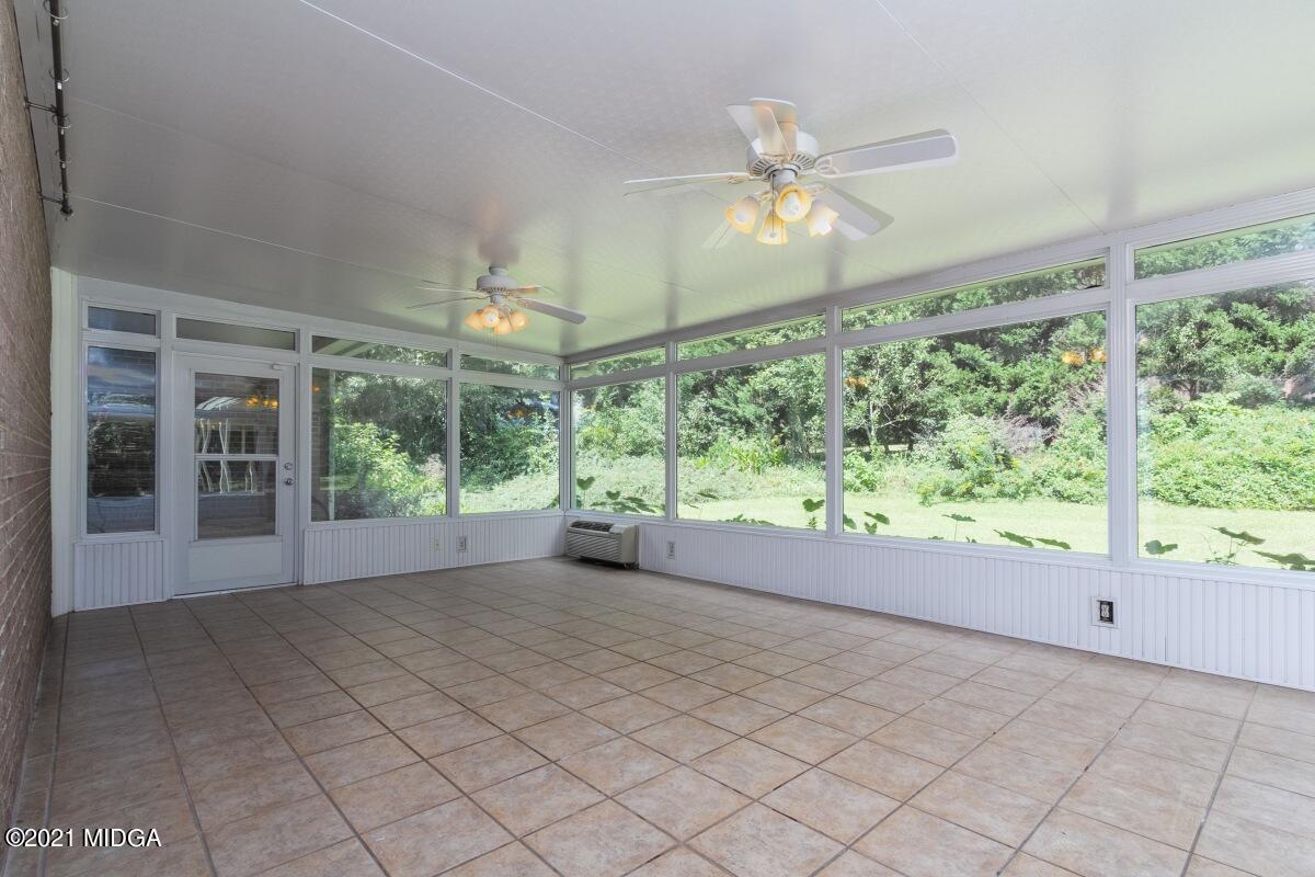 903 Tucker Road Macon, GA 31210 - Photo 22 of 31 a view of an empty room with a window and chandelier