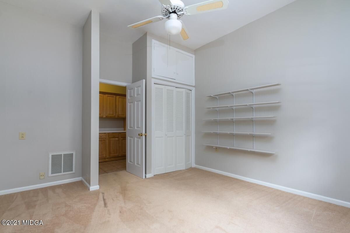 903 Tucker Road Macon, GA 31210 - Photo 25 of 31 a view of an empty room with a ceiling fan and a window