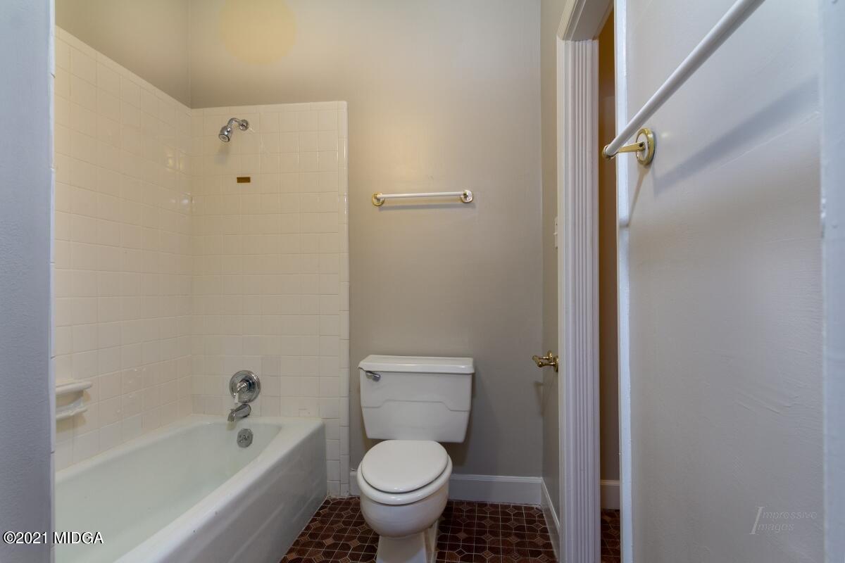 903 Tucker Road Macon, GA 31210 - Photo 28 of 31 a bathroom with a toilet and a bathtub