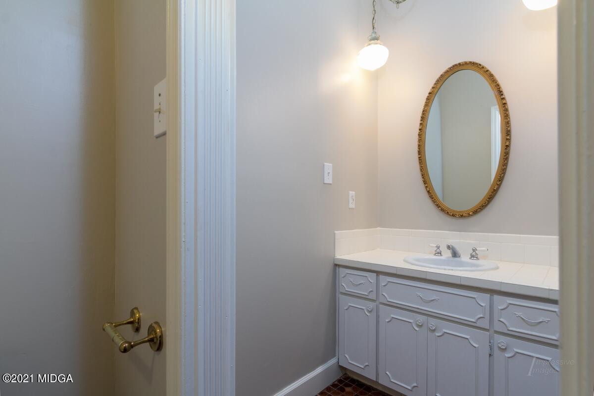 903 Tucker Road Macon, GA 31210 - Photo 29 of 31 a bathroom with a sink and a mirror
