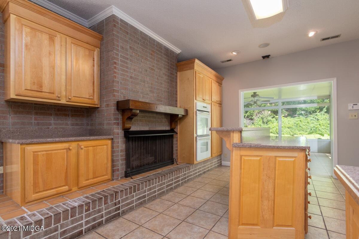 903 Tucker Road Macon, GA 31210 - Photo 10 of 31 a kitchen with granite countertop cabinets stainless steel appliances and a window