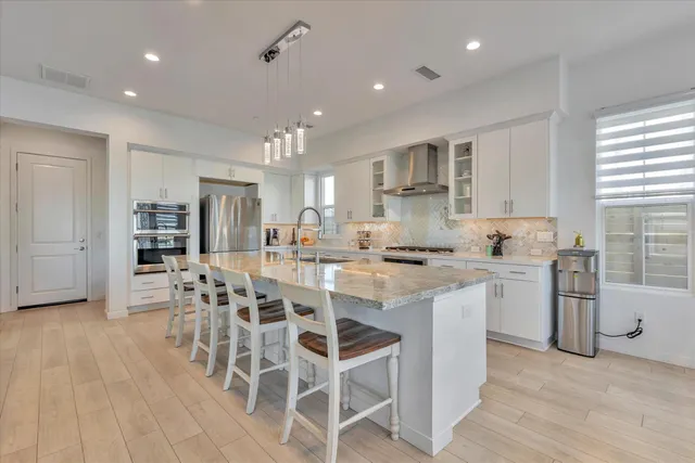 a bathroom with a sink mirror vanity and toilet