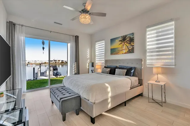 a bedroom with a bed and a chandelier