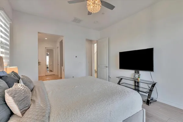 a large white kitchen with a large window cabinets and stainless steel appliances