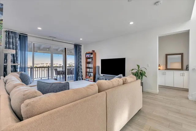 a view of a dining room with furniture wooden floor and next to a window