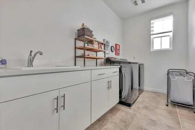 an outdoor sitting area with furniture and city view
