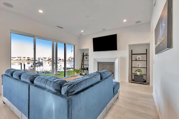 a living room with furniture and kitchen view