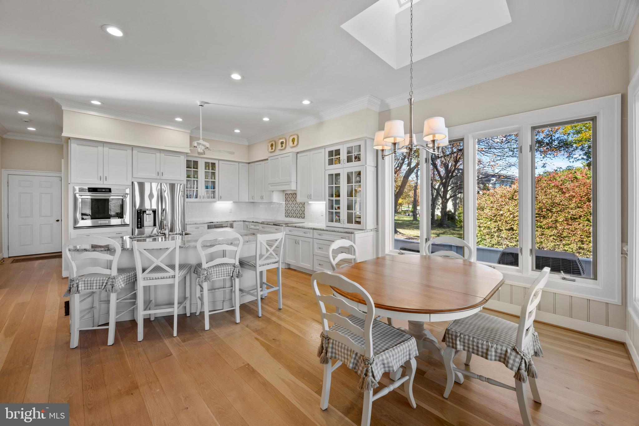 2907 Cox Neck Road East Chester, MD 21619 - Photo 12 of 43 a dining room with stainless steel appliances kitchen island granite countertop a table chairs and a view of living room