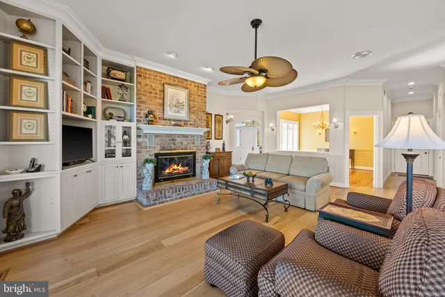 a living room with furniture flat screen tv and a large window