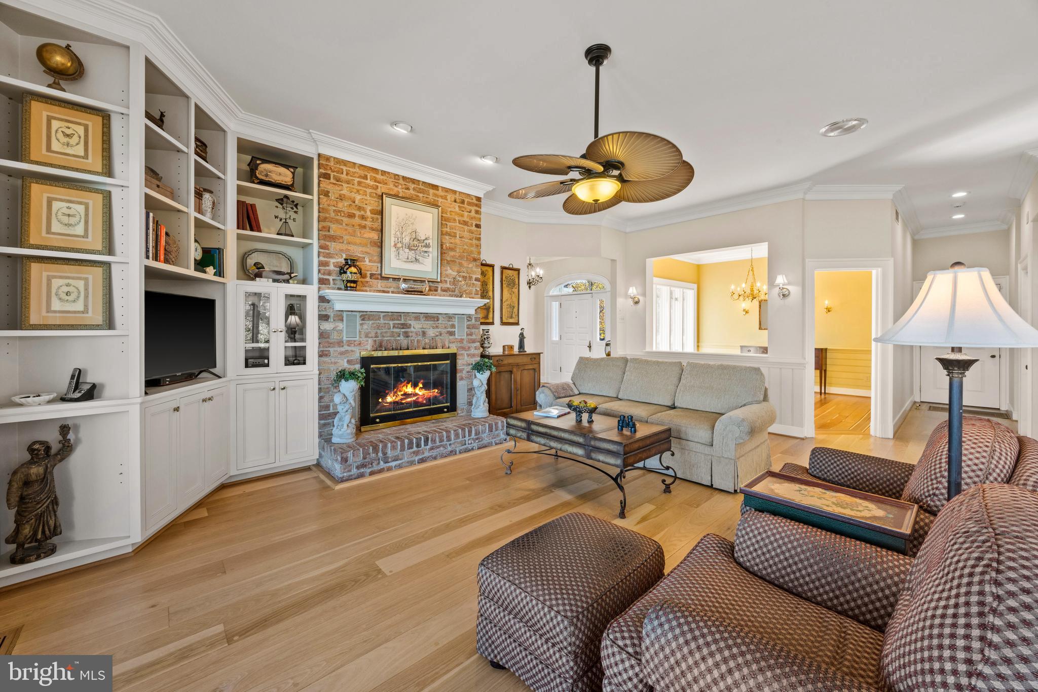2907 Cox Neck Road East Chester, MD 21619 - Photo 15 of 43 a living room with furniture fireplace and a chandelier