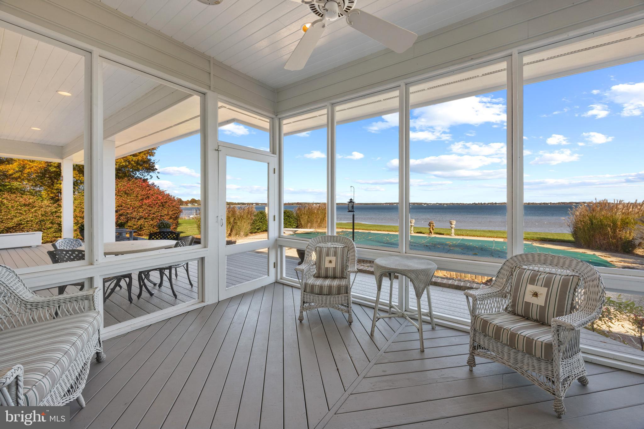 2907 Cox Neck Road East Chester, MD 21619 - Photo 17 of 43 a view of a living room and balcony with wooden floor and furniture