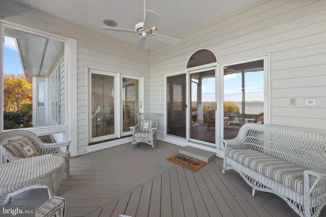 a view of a swimming pool with lawn chairs and plants