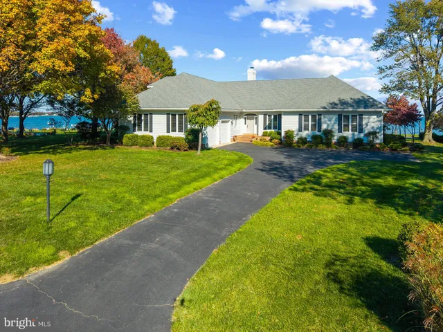 a front view of a house with a yard table and chairs
