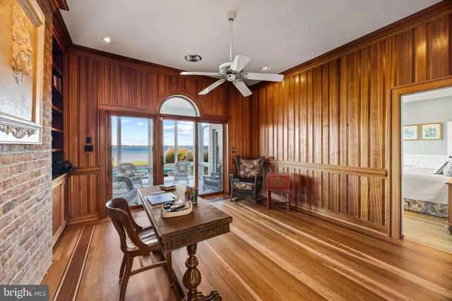 a view of a room with a chandelier and wooden floor