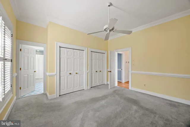 an empty room with windows and fireplace