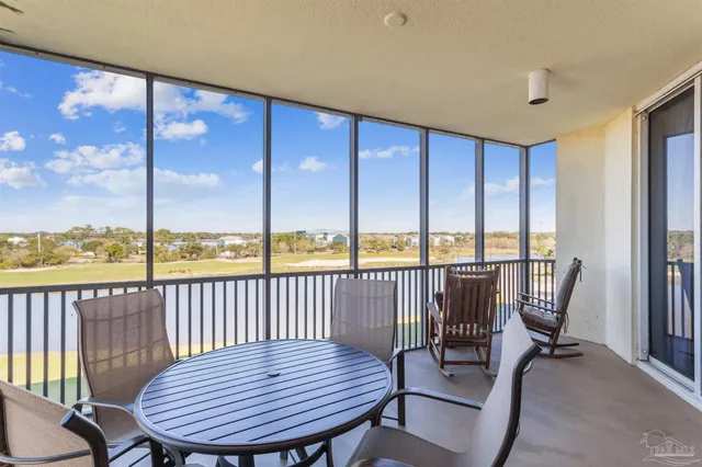 a view of a city from a balcony with furniture