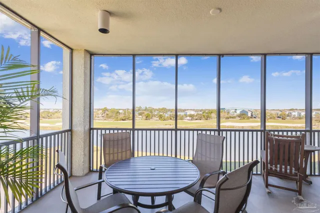 a view of a livingroom with furniture and floor to ceiling window