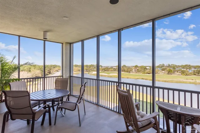 a dining room with lots of wooden furniture and a chandelier