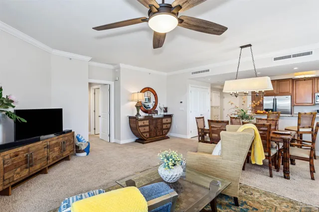 a dining room with stainless steel appliances kitchen island a table and chairs
