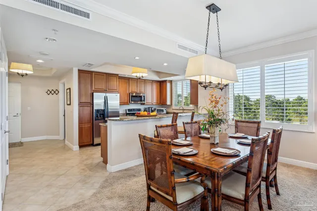 a large kitchen with stainless steel appliances granite countertop a refrigerator a stove and a sink