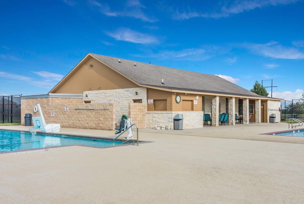 329 Yearwood Lane, Unit 11C Jarrell, TX 76537 - Photo 2 of 10 a front view of a house with a yard