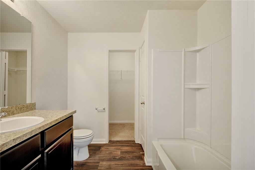 329 Yearwood Lane, Unit 11C Jarrell, TX 76537 - Photo 4 of 10 a bathroom with a sink a toilet and shower