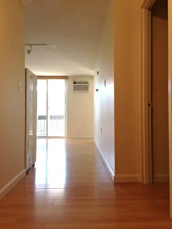 a view of an empty room and wooden floor