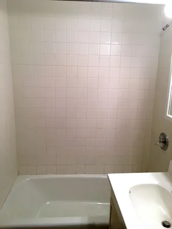 a bathroom with a white bath tub and a shower curtain