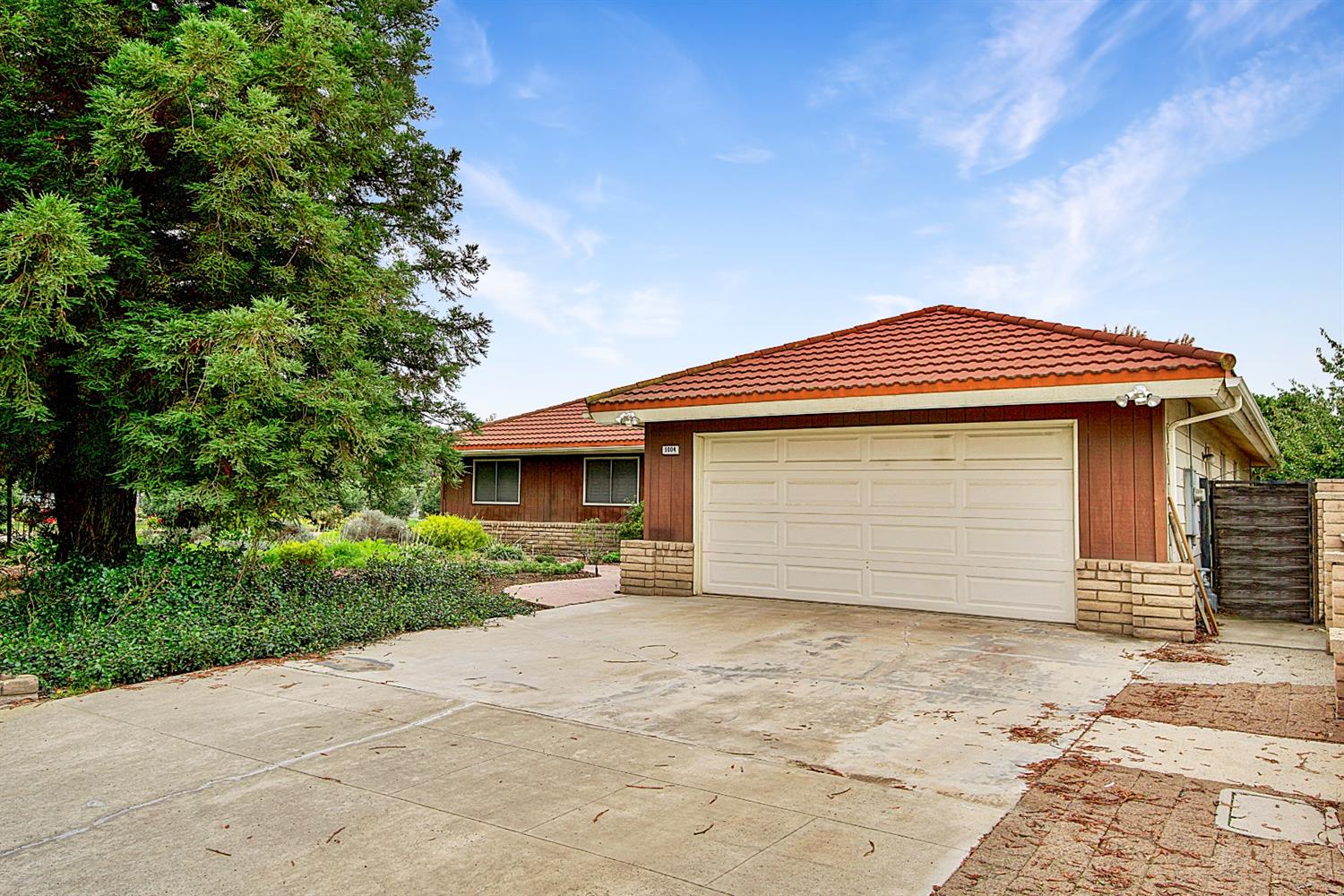 1004 Joy Street Madera, CA 93637 - Photo 2 of 29 a front view of a house with a yard and garage