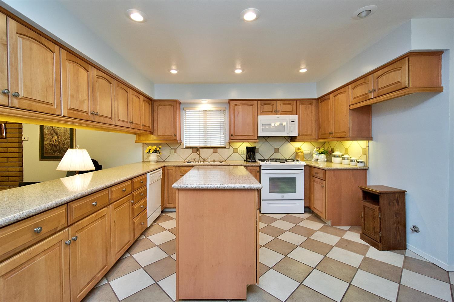 1004 Joy Street Madera, CA 93637 - Photo 12 of 29 a kitchen with stainless steel appliances granite countertop a sink and cabinets