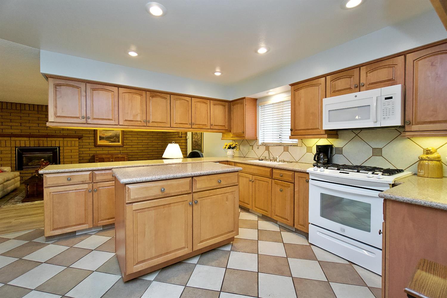 1004 Joy Street Madera, CA 93637 - Photo 14 of 29 a kitchen with stainless steel appliances granite countertop a sink and cabinets