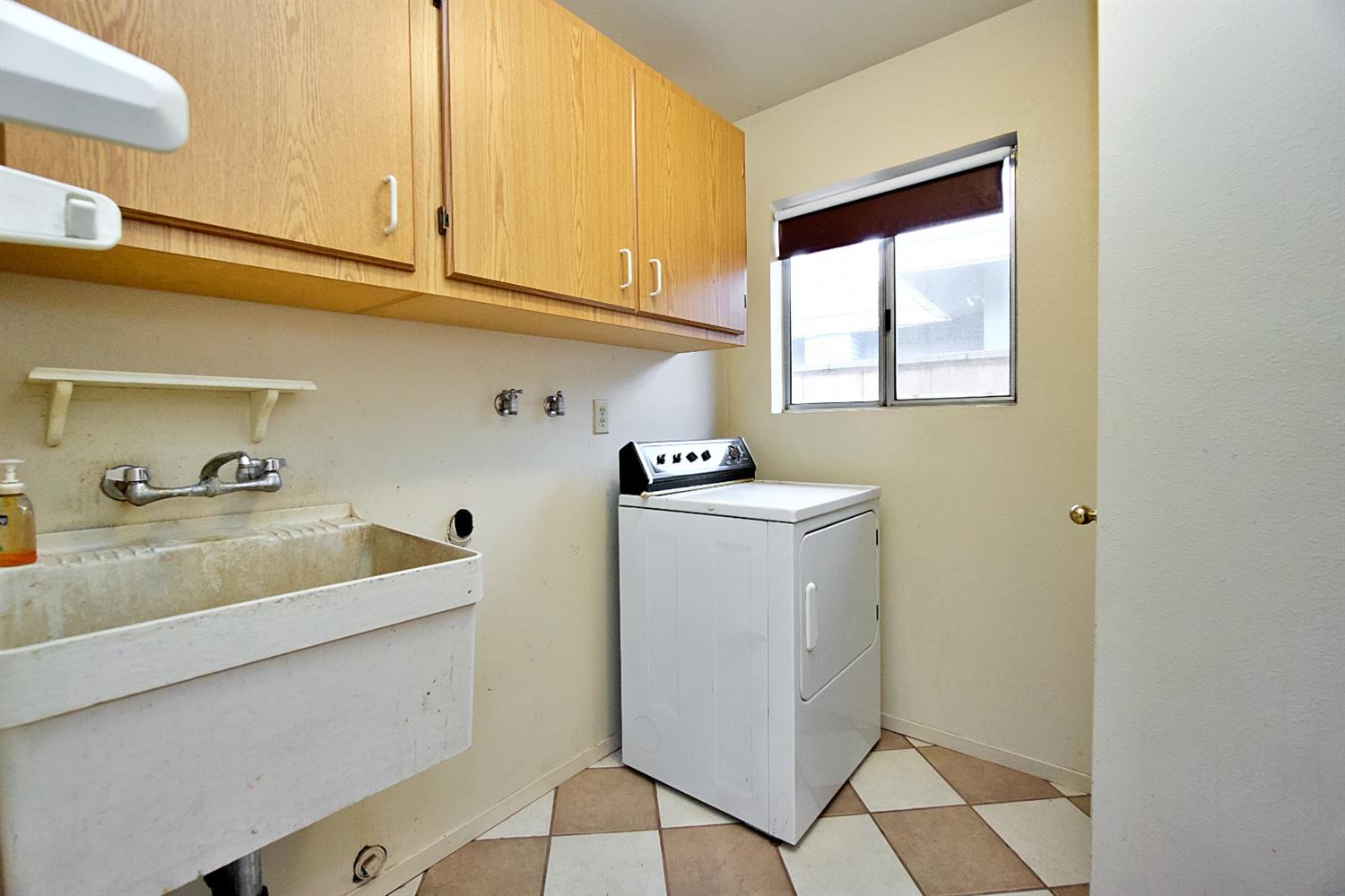 1004 Joy Street Madera, CA 93637 - Photo 16 of 29 a utility room with cabinets washer and dryer