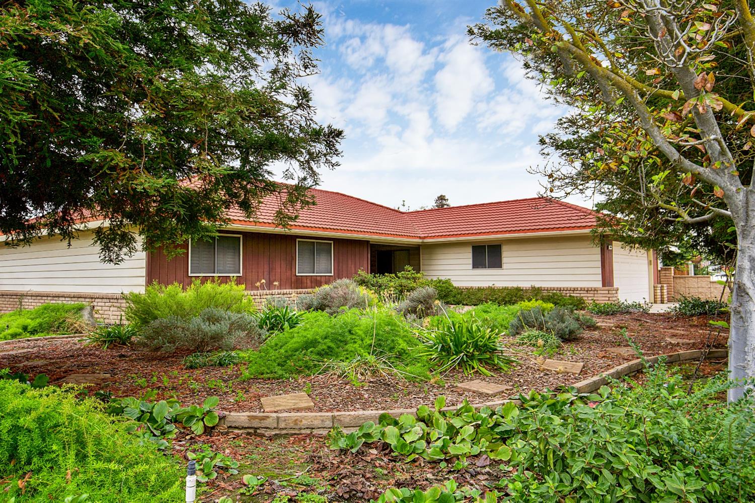 1004 Joy Street Madera, CA 93637 - Photo 3 of 29 a front view of a house with garden