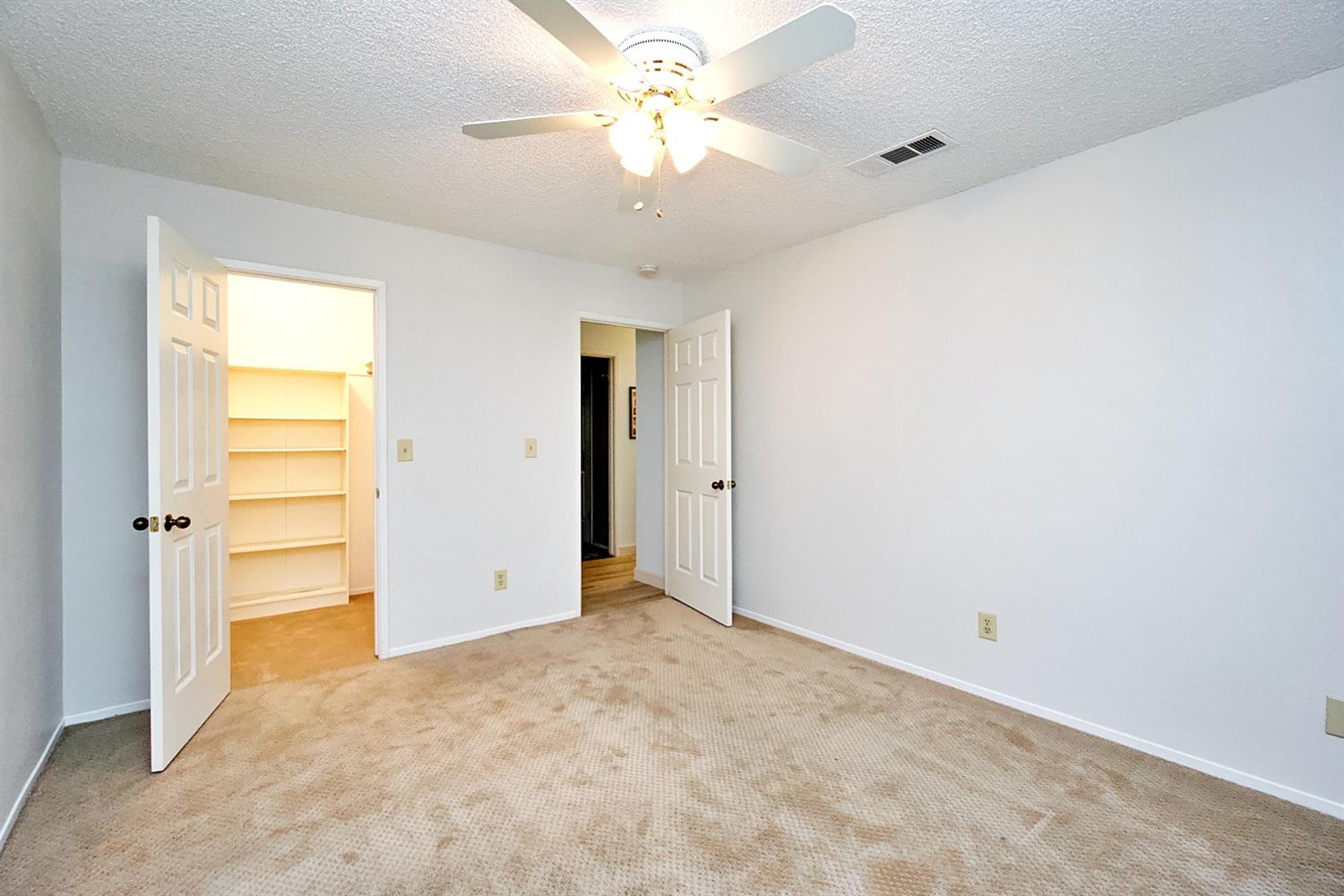 1004 Joy Street Madera, CA 93637 - Photo 24 of 29 an empty room with closet and a chandelier fan