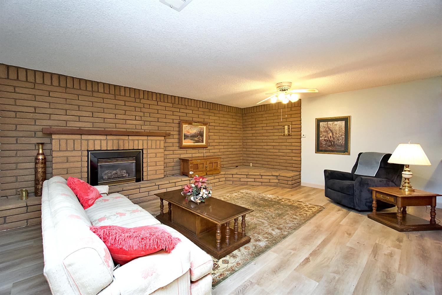 1004 Joy Street Madera, CA 93637 - Photo 10 of 29 a living room with furniture rug and fireplace
