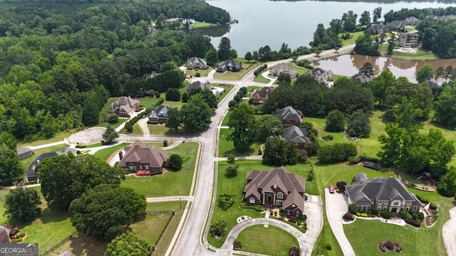 an aerial view of residential house with outdoor space and lake view