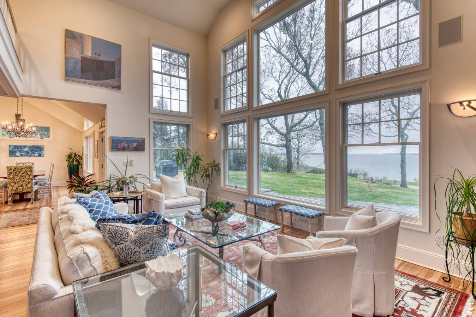 a living room with furniture and floor to ceiling windows