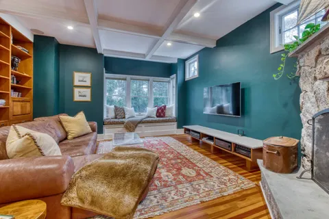 a living room with furniture rug and window