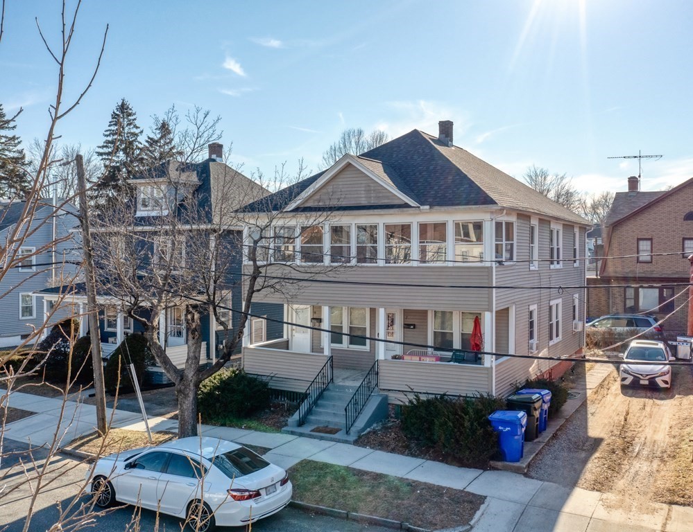 7-9 Kosciusko Street Springfield, MA 01151 - Photo 1 of 21 a front view of a house with a garden and sitting area
