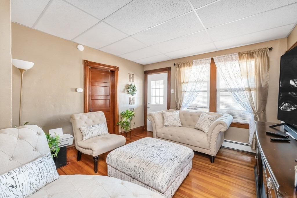7-9 Kosciusko Street Springfield, MA 01151 - Photo 8 of 21 a living room with furniture and a flat screen tv