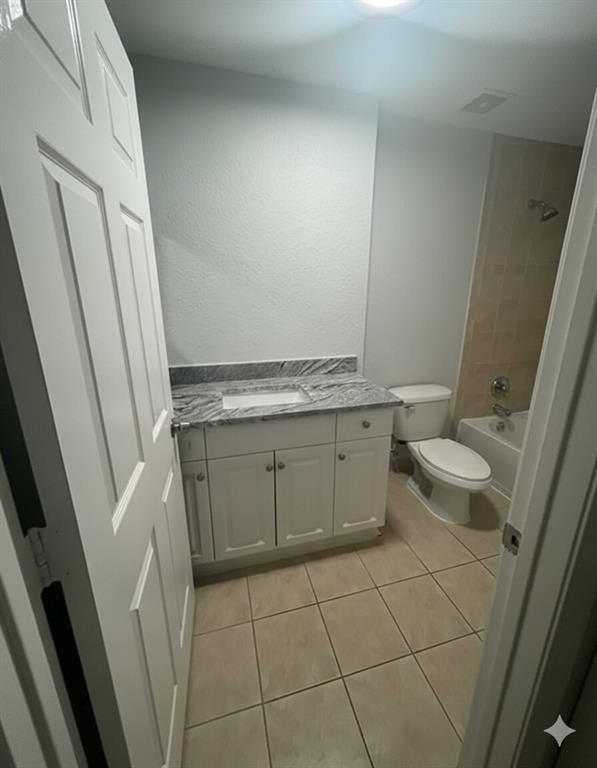 2801 Riverside Drive, Unit 204 Coral Springs, FL 33065 - Photo 15 of 18 a bathroom with a granite countertop toilet and a sink
