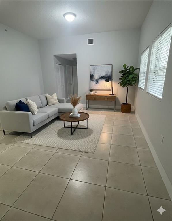 2801 Riverside Drive, Unit 204 Coral Springs, FL 33065 - Photo 17 of 18 a living room with furniture and potted plant