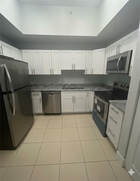 2801 Riverside Drive, Unit 204 Coral Springs, FL 33065 - Photo 2 of 18 a kitchen with stainless steel appliances granite countertop a refrigerator sink and cabinets