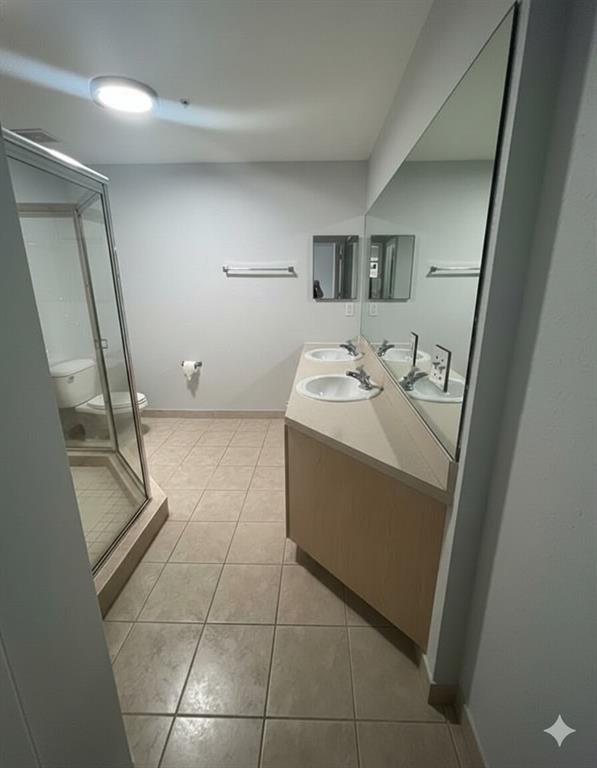 2801 Riverside Drive, Unit 204 Coral Springs, FL 33065 - Photo 5 of 18 a bathroom with a sink a toilet and a mirror