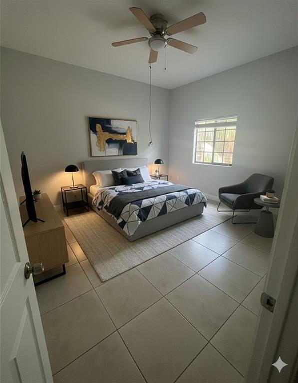 2801 Riverside Drive, Unit 204 Coral Springs, FL 33065 - Photo 6 of 18 a bedroom with furniture and a window