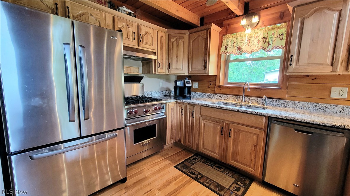 4325 Pleasant Ridge Road Marietta, OH 45750 - Photo 5 of 35 Kitchen with light hardwood / wood-style floors, light stone countertops, appliances with stainless steel finishes, beam ceiling, and wood ceiling