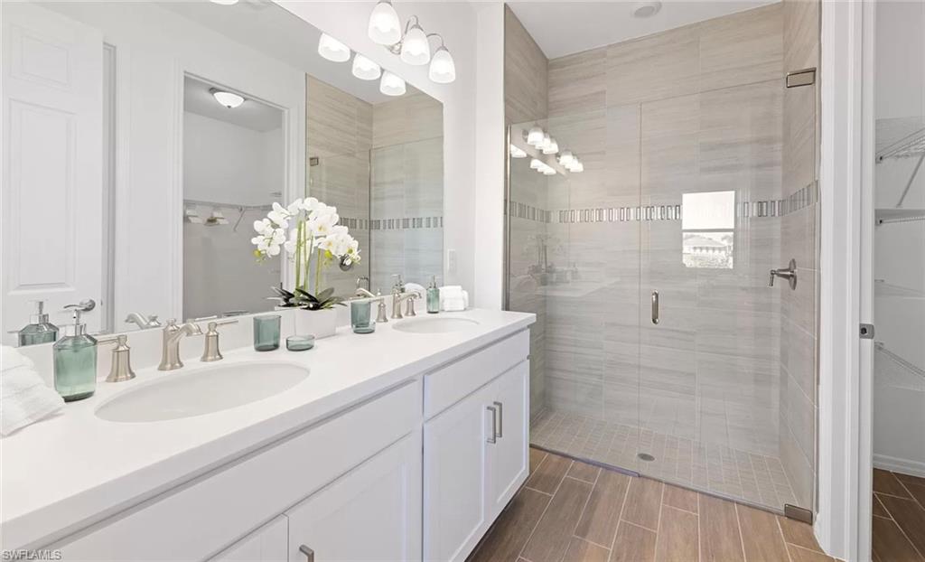 1213 Enbrook Loop Naples, FL 34114 - Photo 13 of 24 a bathroom with a double vanity sink mirror and shower