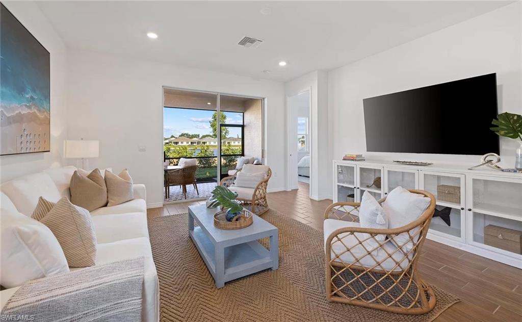 1213 Enbrook Loop Naples, FL 34114 - Photo 8 of 24 a living room with furniture and a flat screen tv